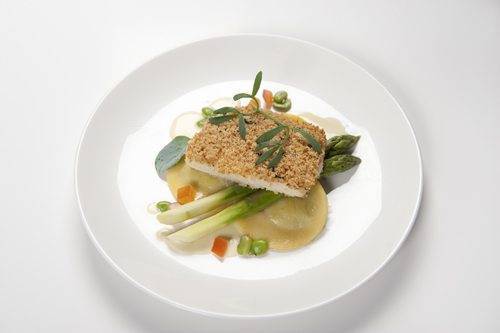 Fillet of halibut with a truffled herb crust, sea herbs, asparagus, crushed broad beans and pumpkin ravioli, with a champagne beurre blanc