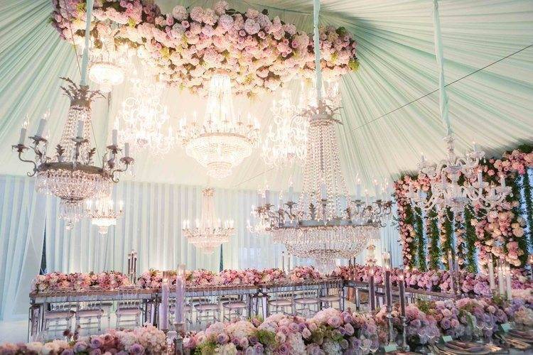A gorgeous combination of sparkling chandeliers and abundant florals Photo: White Lilac Inc