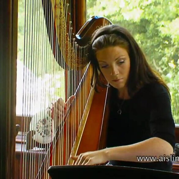 Woman playing harp in sunlit room