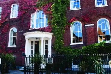 Historic red-brick building with ivy-covered facade.
