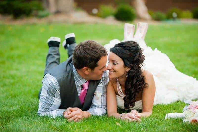 Bride and Groom Lying On Grass