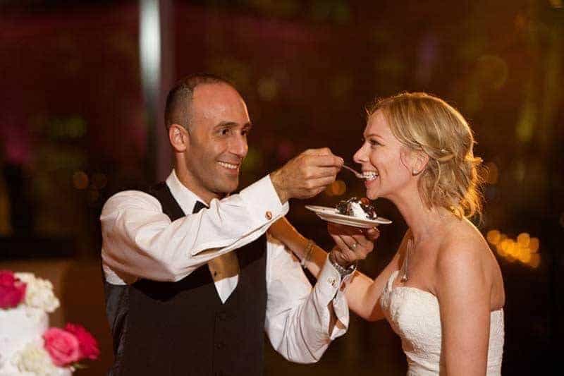 A Garden Wedding In New York Groom Feeding Bride Cake