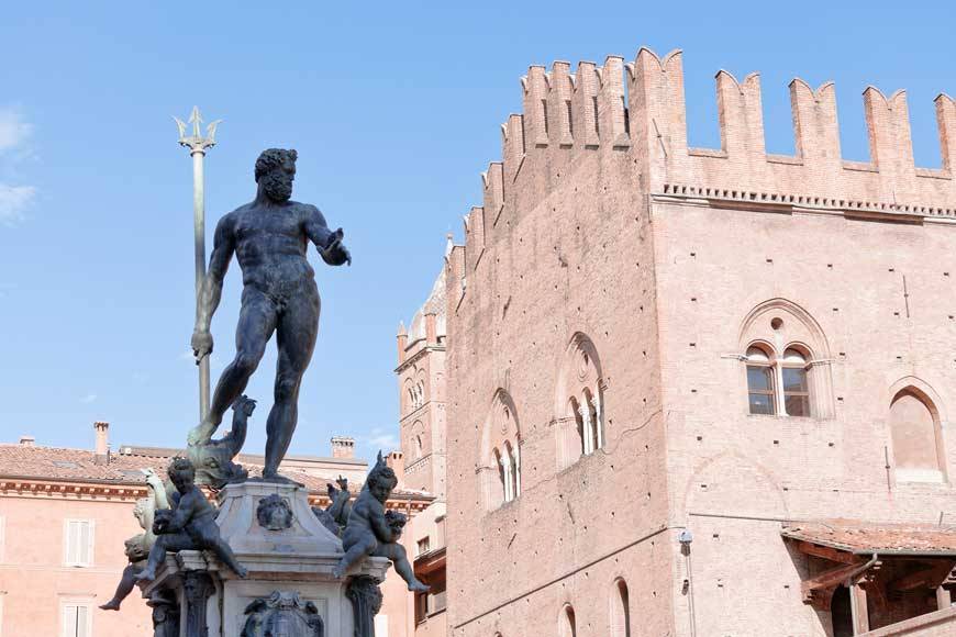 Vvoe - sculpture of Fountain of Neptune on Piazza del Nettuno and Re Enzo palace in Bologna in sunny day, Italy Vvoe - sculpture of Fountain of Neptune on Piazza del Nettuno and Re Enzo palace in Bologna in sunny day, Italy