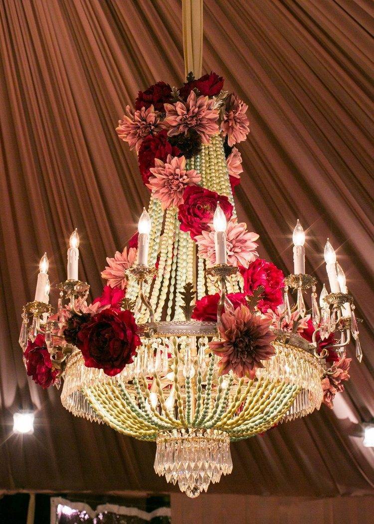 Dripping in crystals and accessorised with flowers - gorgeous chandeliers. Photo: White Lilac Inc