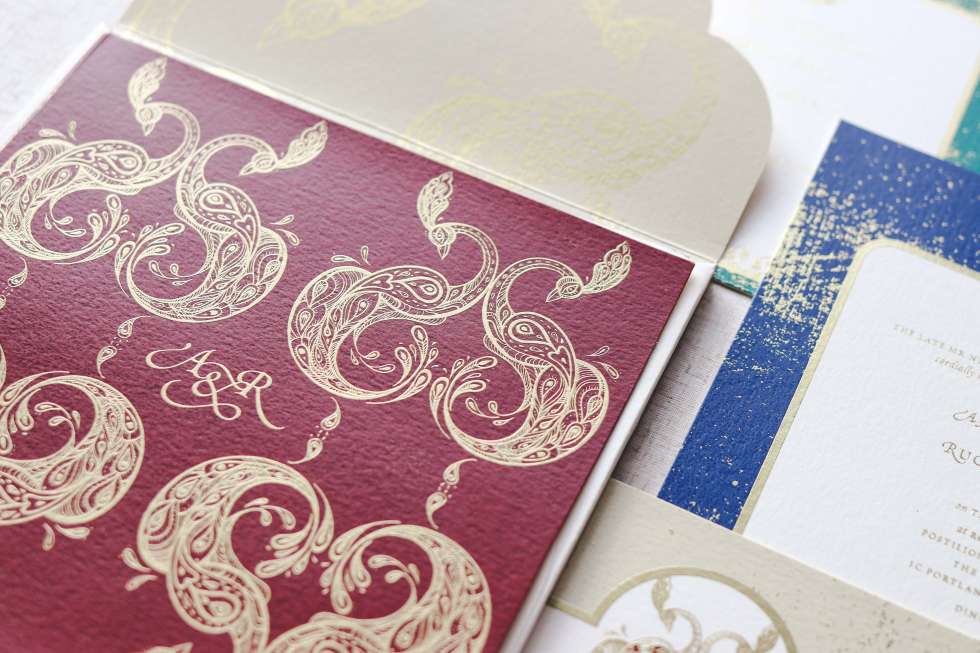 Elegant wedding invitation with intricate gold details.