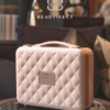 Quilted Beautifect makeup case on table.