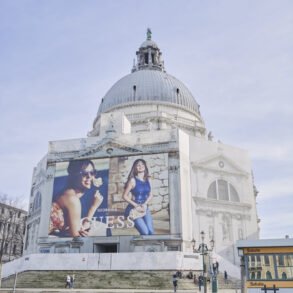Large advertisement on historic building by canal