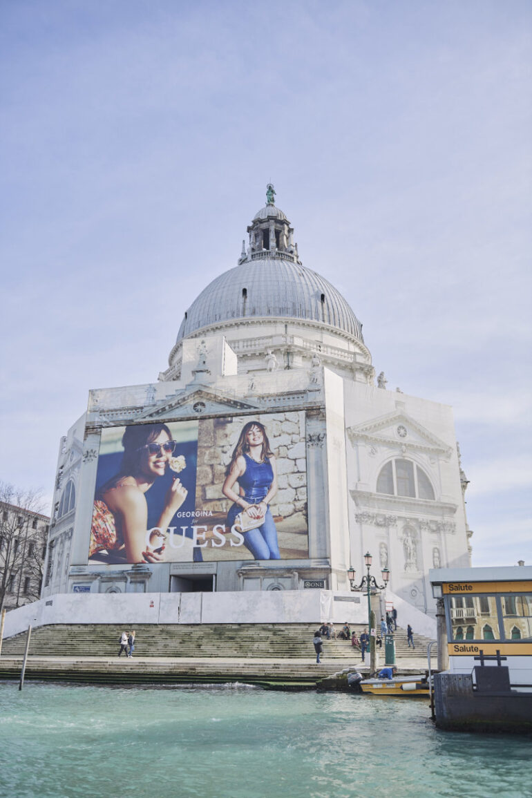 Large advertisement on historic building by canal