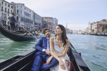 Couple enjoying gondola ride in Venice canal