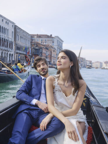 Couple enjoying gondola ride in Venice canal