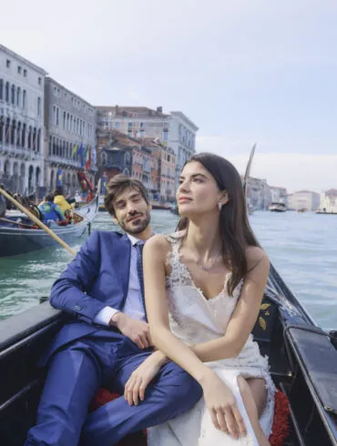 Couple enjoying gondola ride in Venice canal