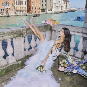 Woman in a wedding dress near Venice canal.