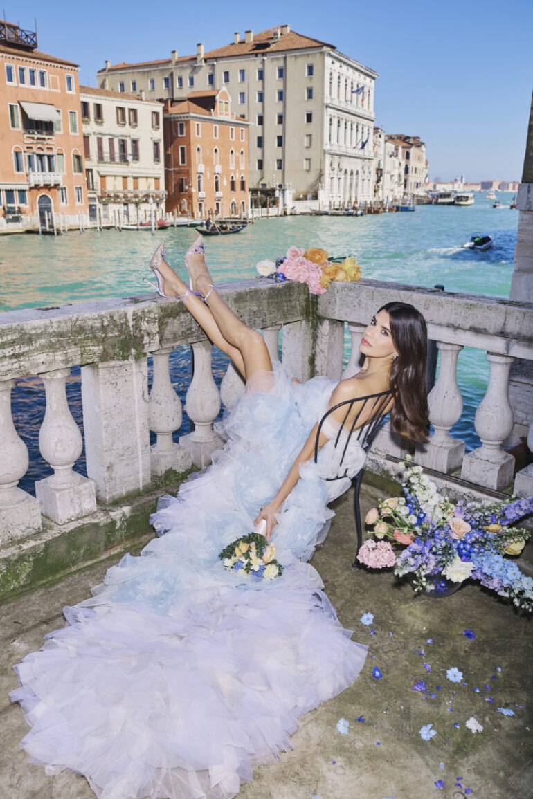 Woman in a wedding dress near Venice canal.