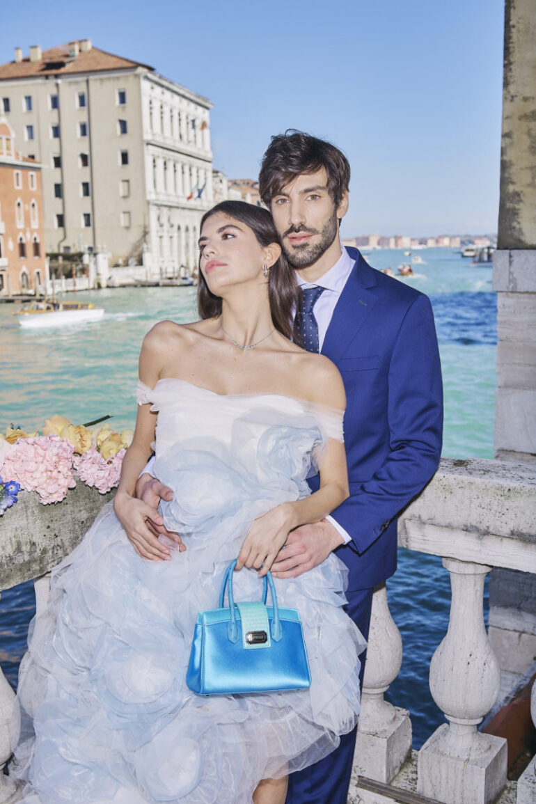 Couple posing by canal in Venice