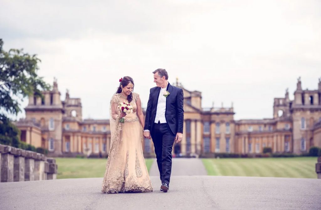 Bespoke Blenheim Wedding Ceremonies & Receptions Bride and groom walking at palace courtyard.
