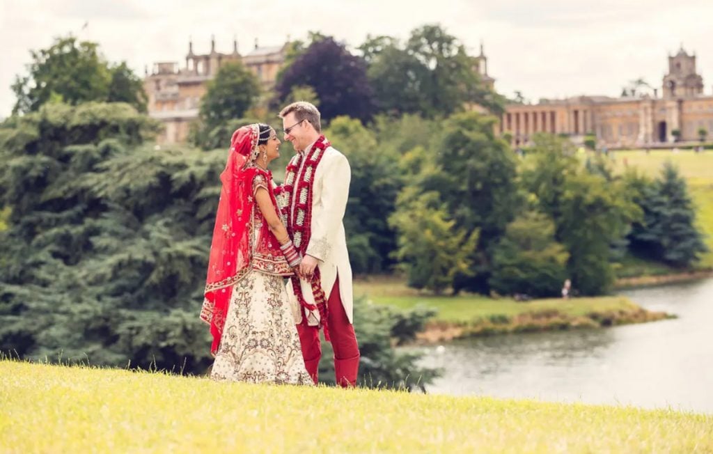 Bespoke Blenheim Wedding Ceremonies & Receptions Couple in traditional wedding attire by a lake