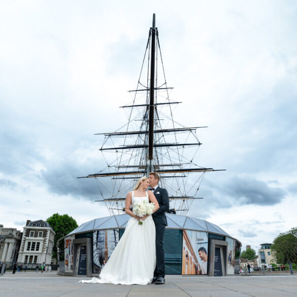 Wedding couple in front of historic ship.