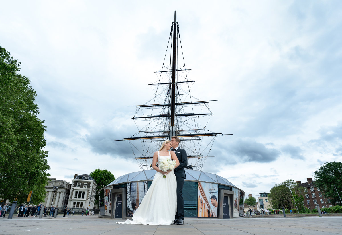 Wedding couple in front of historic ship.