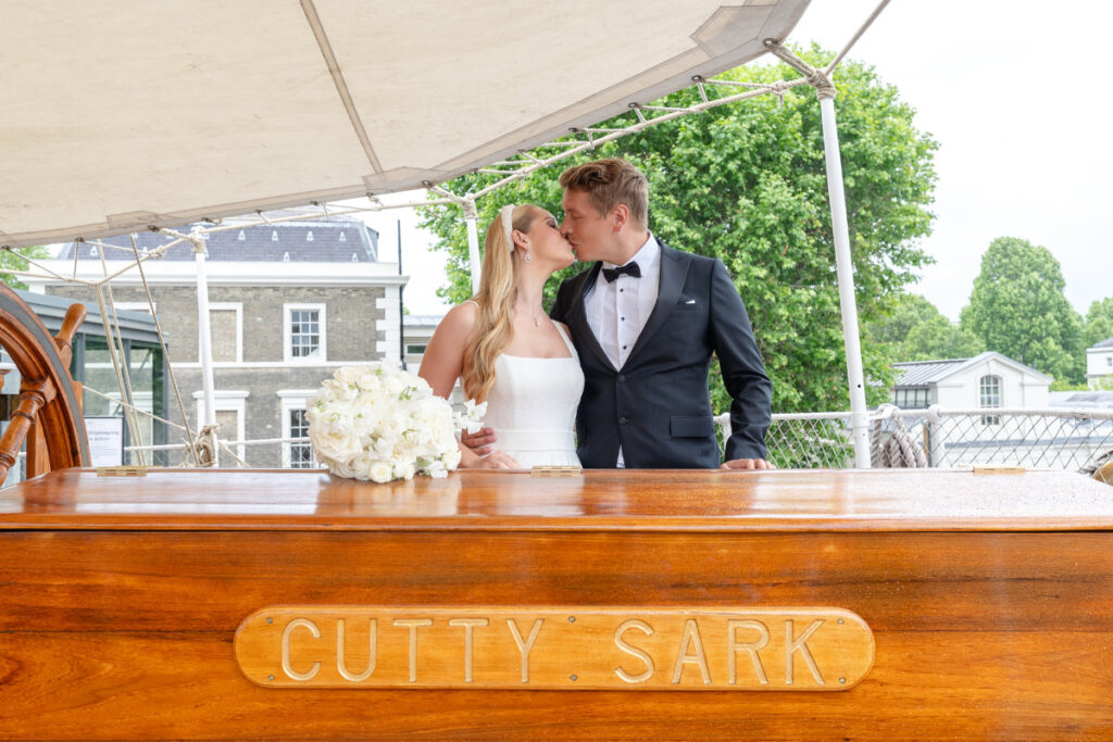 A Nautical Dream: A Timeless Wedding Shoot at Cutty Sark, Greenwich Bride and groom kissing on Cutty Sark