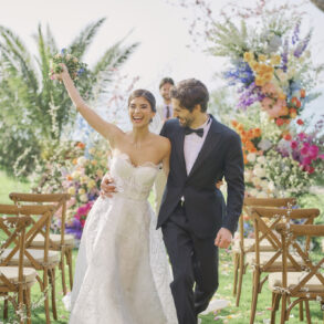 Newlyweds walking down aisle cheerfully