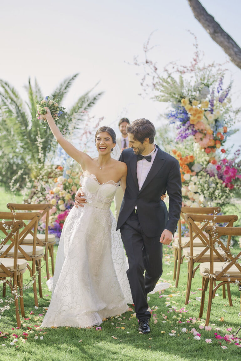 Newlyweds walking down aisle cheerfully