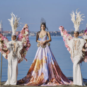 People in extravagant costumes by the water