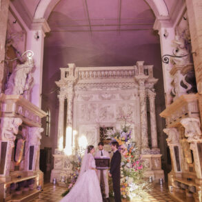 Wedding ceremony in ornate historic church.