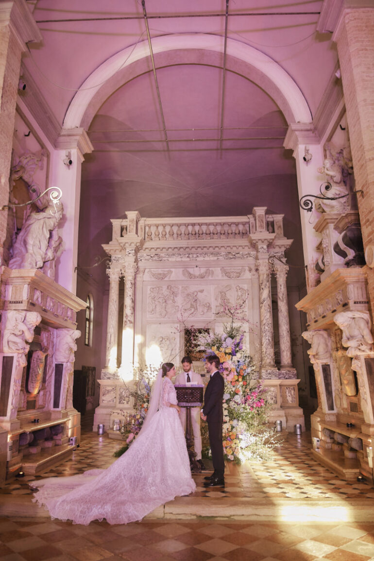 Wedding ceremony in ornate historic church.