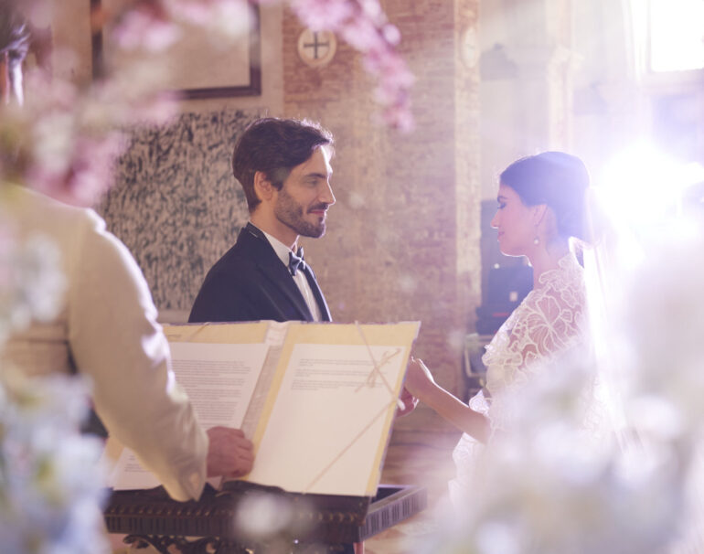 Bride and groom exchanging vows in church