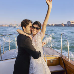 Smiling couple hugging on boat ride