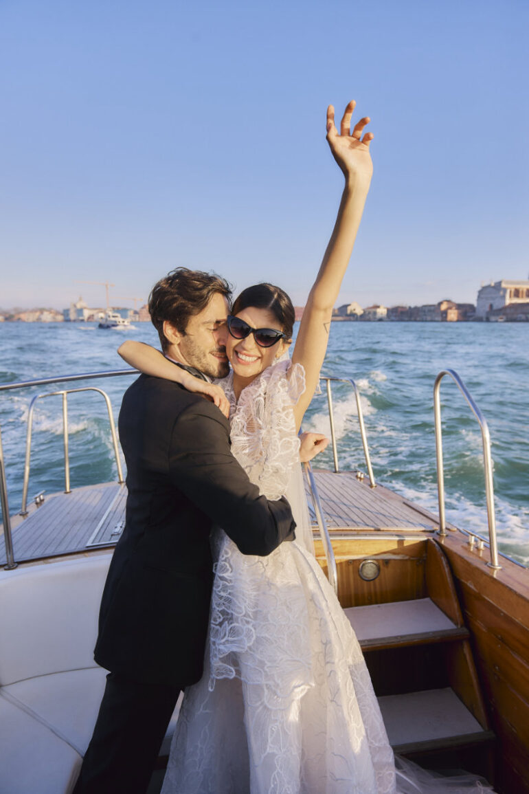 Smiling couple hugging on boat ride