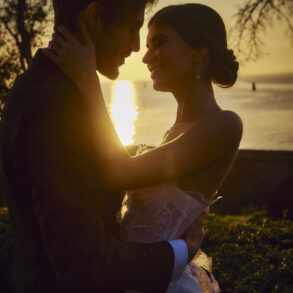 Couple embracing at sunset by the sea.