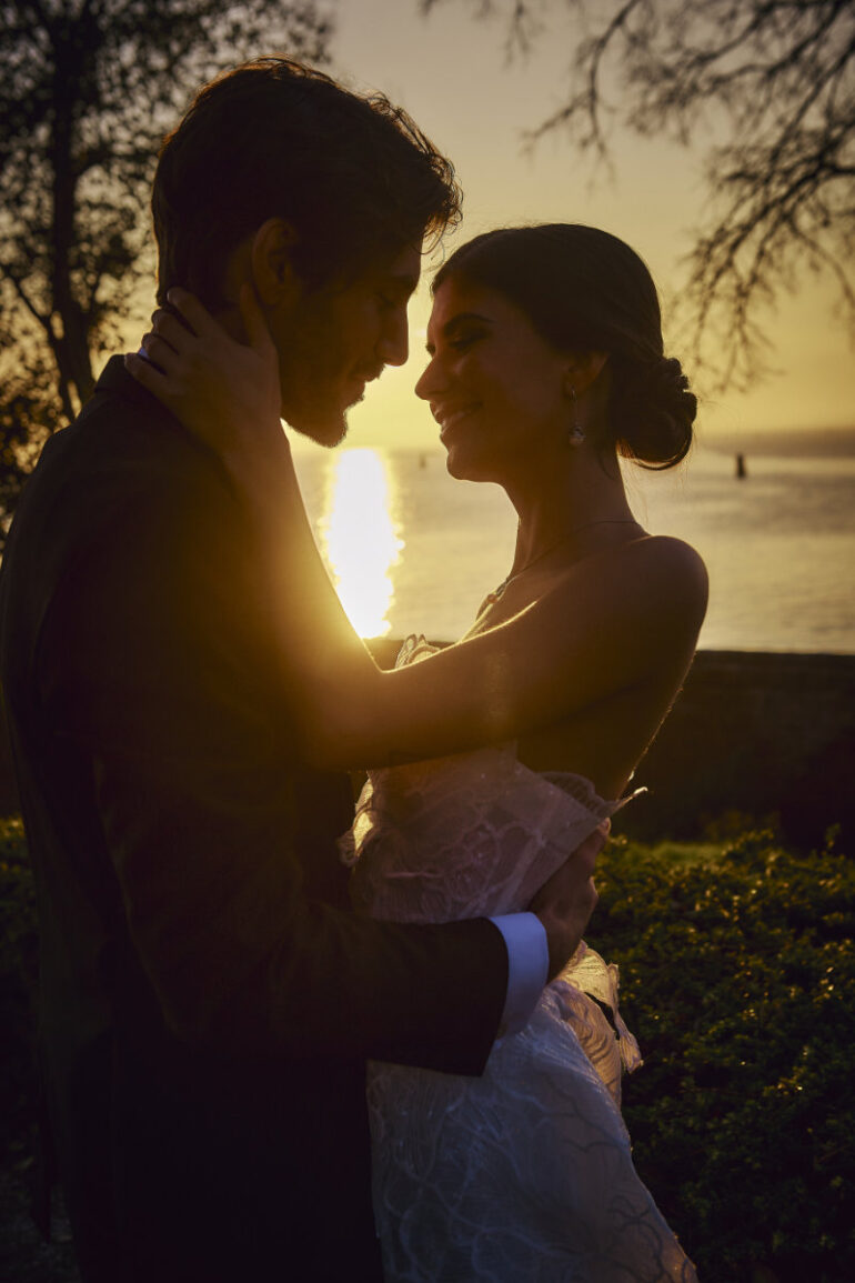 Couple embracing at sunset by the sea.