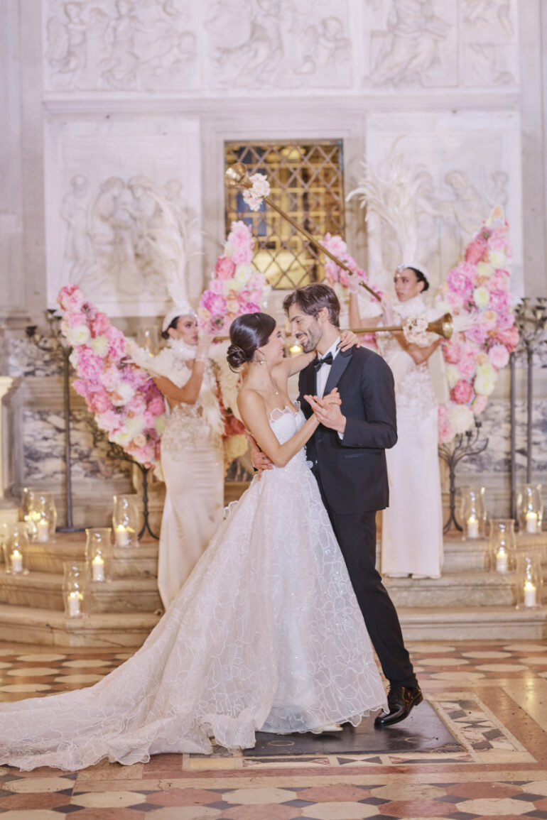 Couple dancing at luxurious wedding reception.