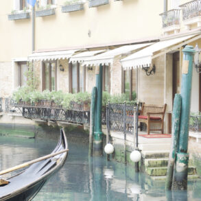 Venetian canal with gondola beside buildings