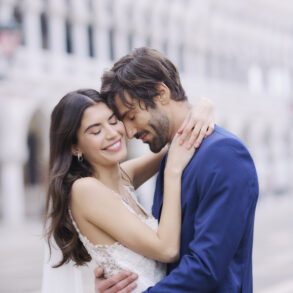 Bride and groom embrace at outdoor wedding