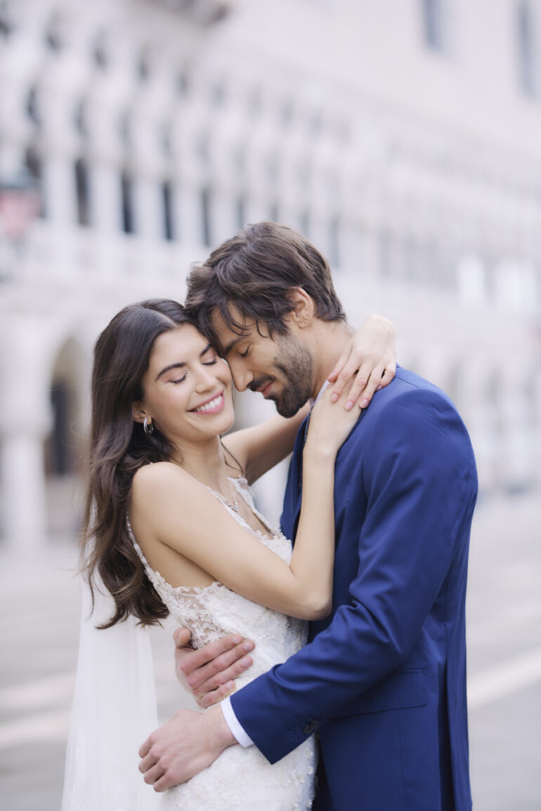 Bride and groom embrace at outdoor wedding