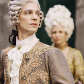 People in 18th century costumes and wigs.