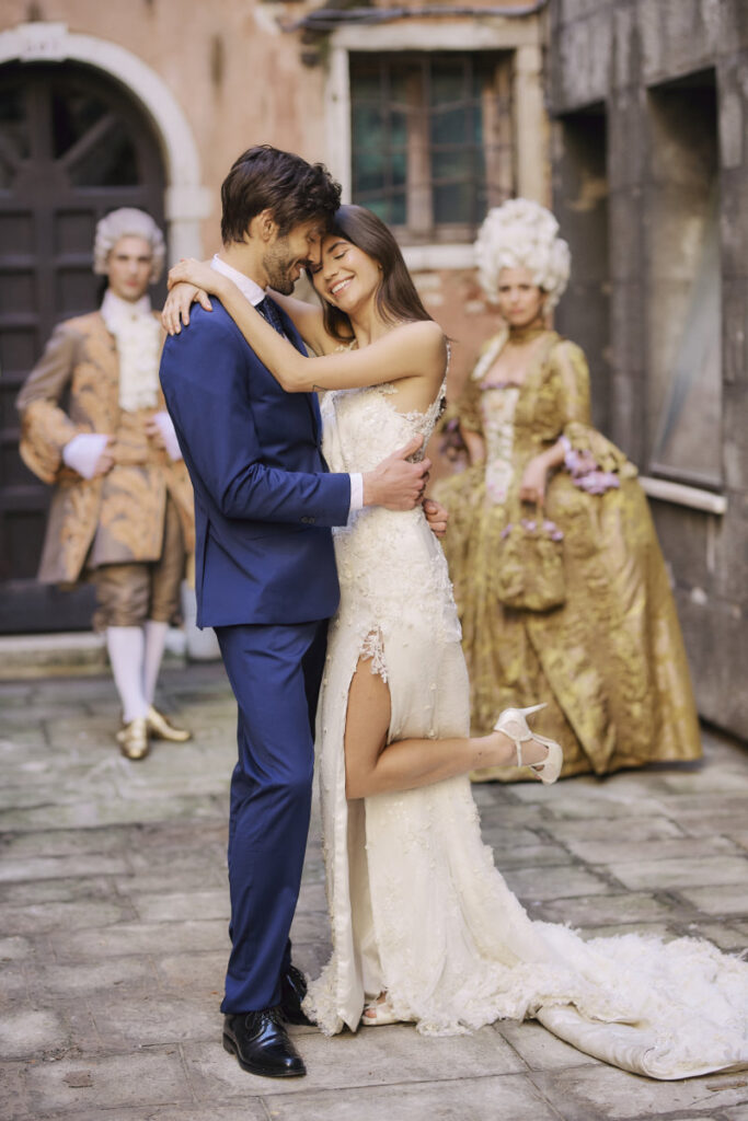 A Vision Of Venice Weddings Happy couple embrace at vintage-themed wedding.