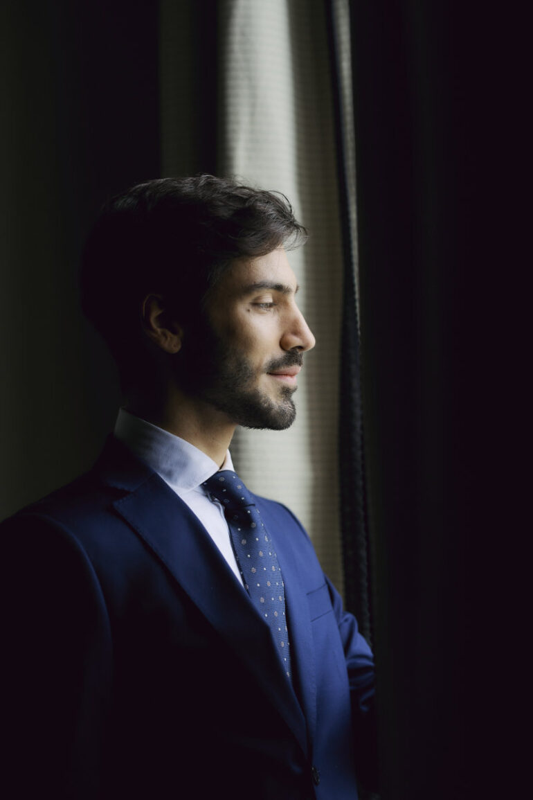 Man in suit looking out window