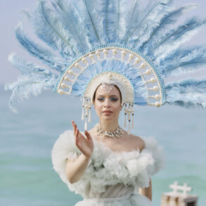 Woman in elaborate costume by the sea