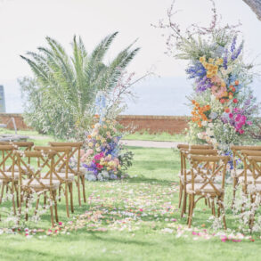 Outdoor wedding setup with colourful flower arrangements