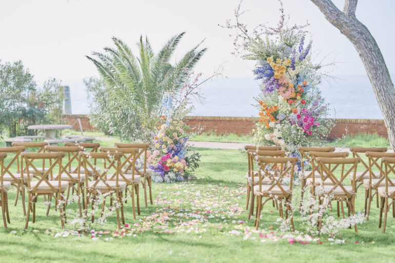 Outdoor wedding setup with colourful flower arrangements