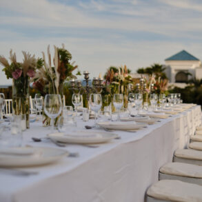 Elegant outdoor banquet with decorated table.