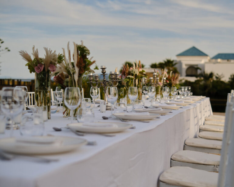 Elegant outdoor banquet with decorated table.