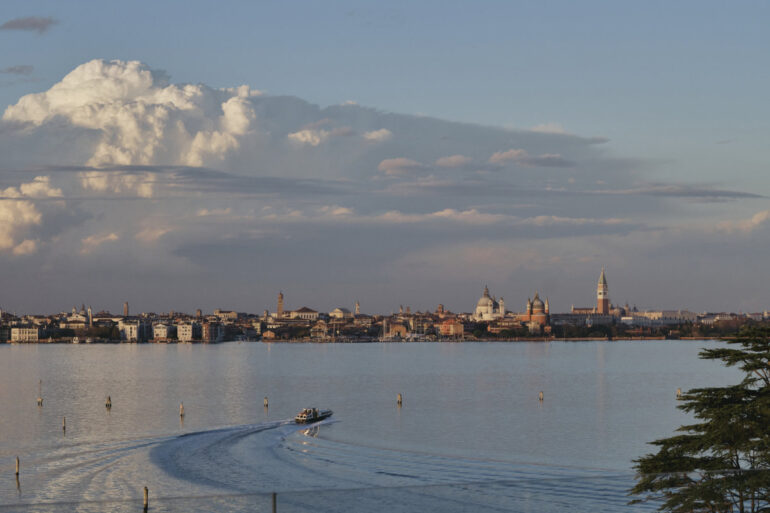 Venice skyline with boat on calm water