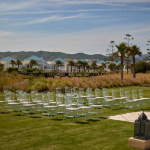 Outdoor wedding venue with chairs and arch.