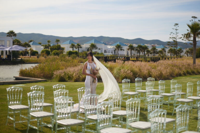 Bride standing in outdoor wedding venue.