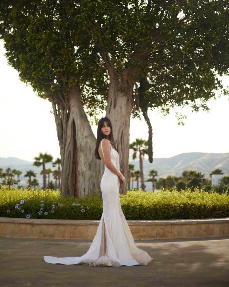 Woman in elegant white dress outdoors