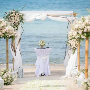 Beach wedding arch with floral decorations.